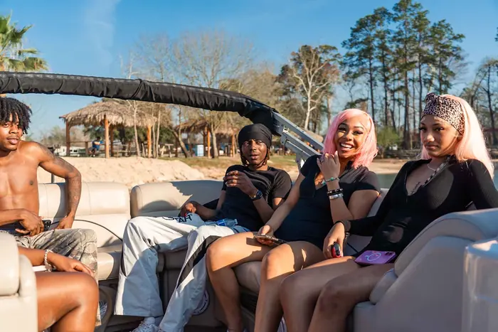Group relaxing on the TH Exotic pontoon boat