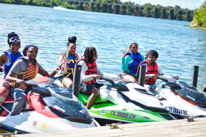 Riders in life jackets at the dock before launch