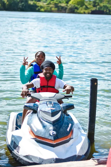 Riders throwing up peace signs on a jet ski
